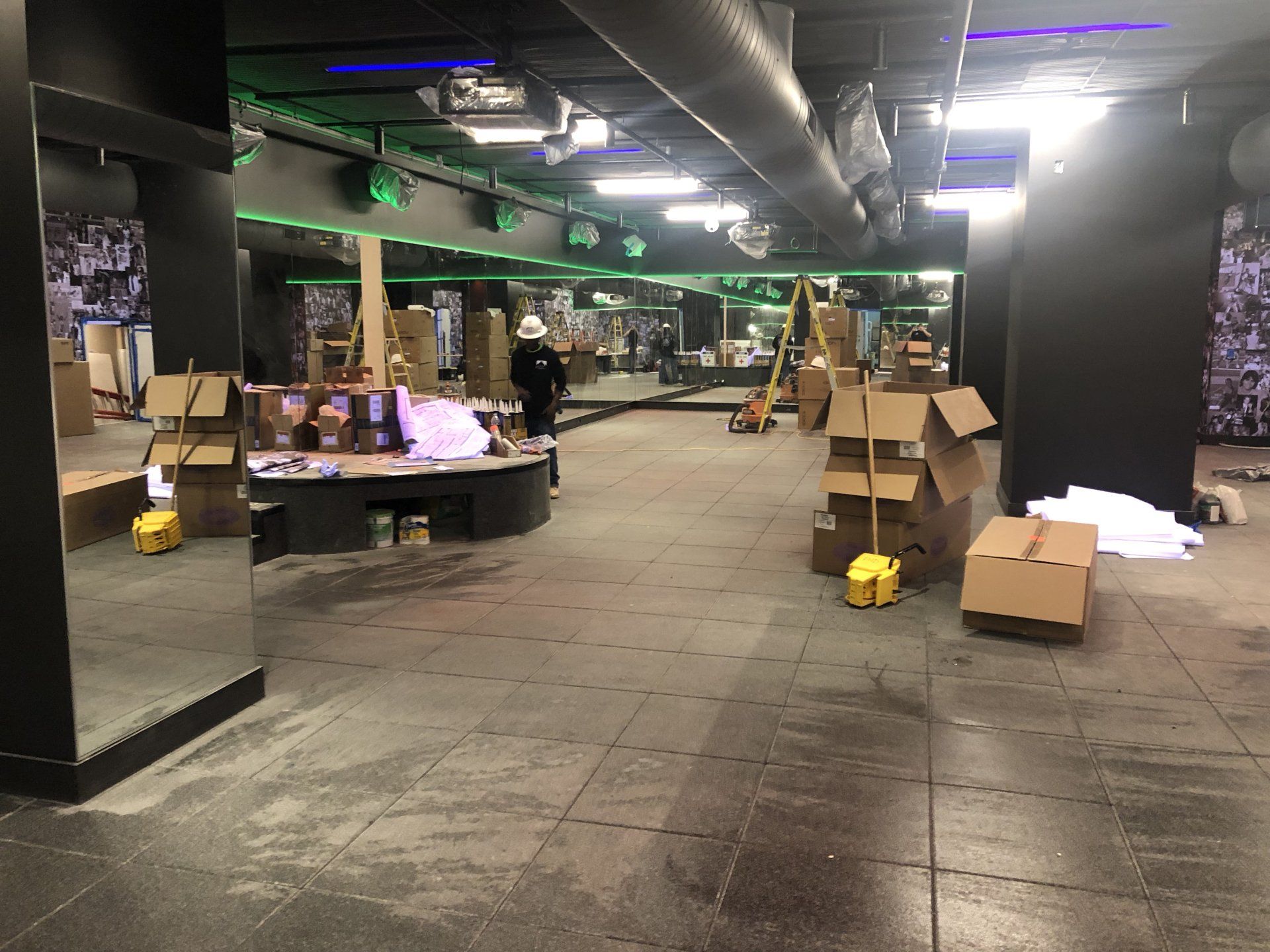 Rumble Fitness studio interior being set up with mirrors and unpacked boxes.