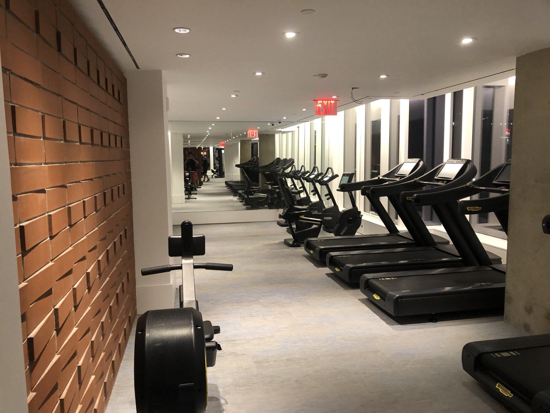 Modern apartment gym with treadmills and strength equipment in Williamsburg Waterfront Apartments.