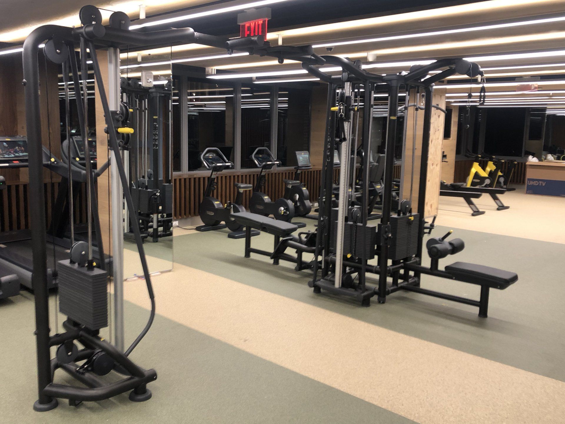 Multi-station weight machines in the modern Iron State fitness facility.