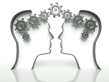 A couple of heads with gears coming out of them.