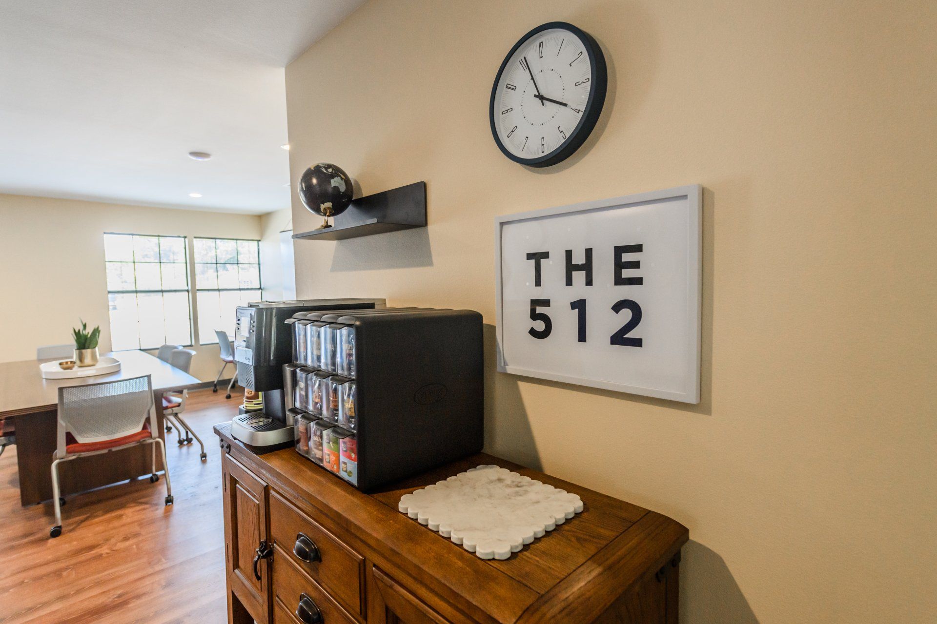 A room with a clock on the wall and a sign that says the 512