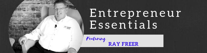 A man is sitting in front of a sign that says entrepreneur essentials