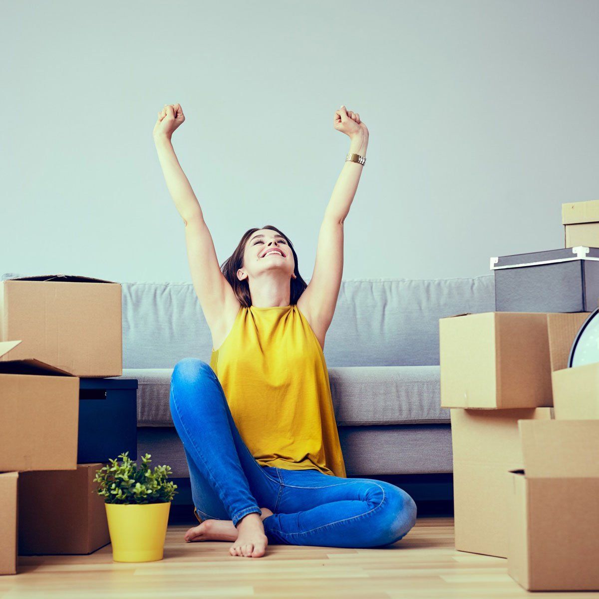 Happy young woman moving to new home - having fun