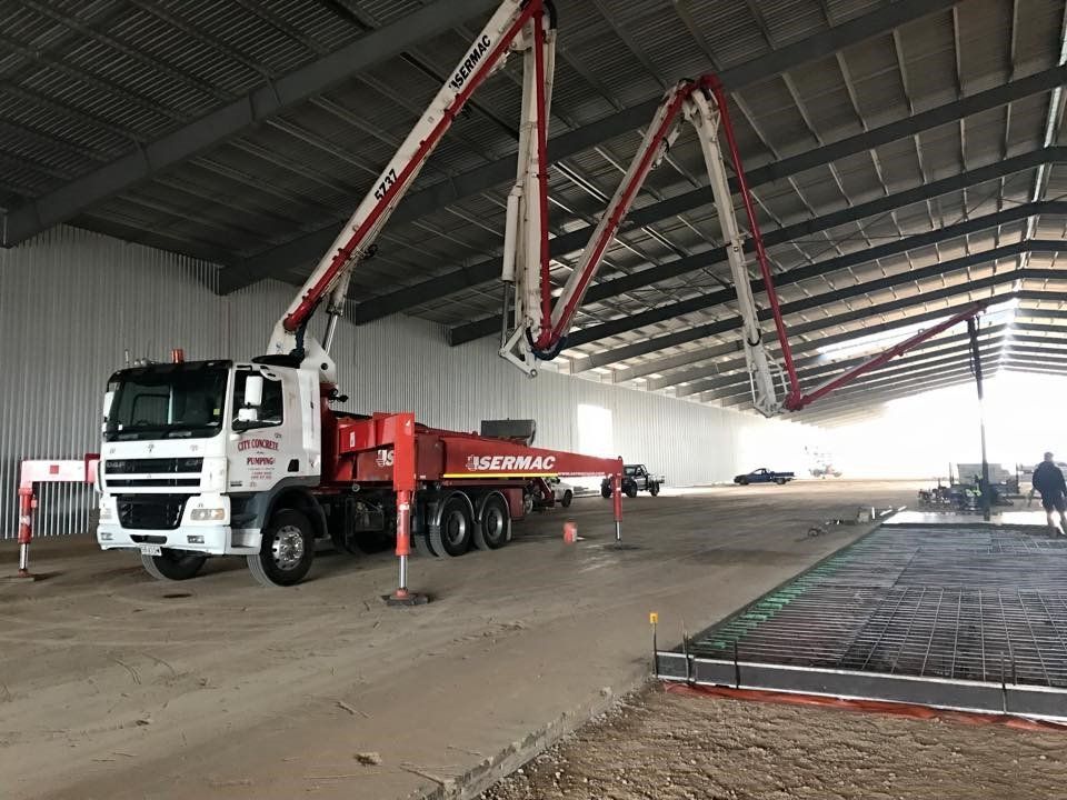 red boom concrete pump truck
