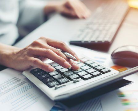 Accountant Making Calculations — Olympia, WA — Bliss & Tuttle, CPAs Accountant Making Calculations — Olympia, WA — Bliss & Tuttle, CPAs