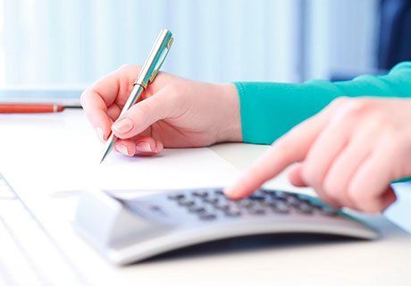 Person Doing Calculations — Olympia, WA — Bliss & Skeen, CPAs