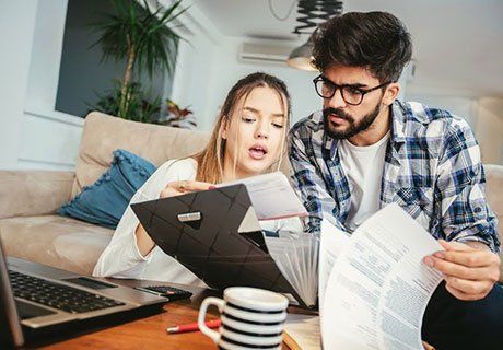 Couple Checking the Bills — Olympia, WA — Bliss & Skeen, CPAs