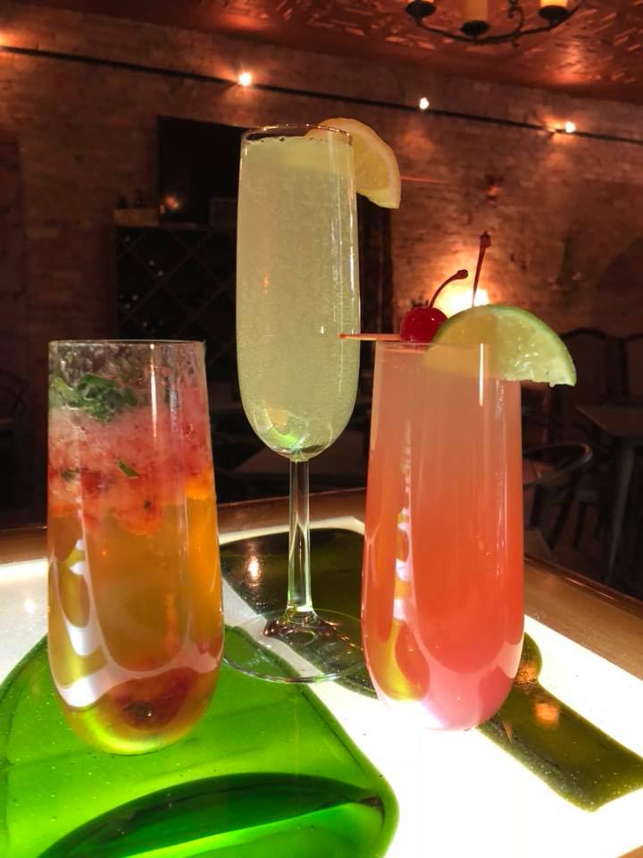 Three different colored drinks are sitting on a table