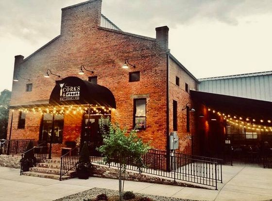 A brick building with a black awning and lights on it