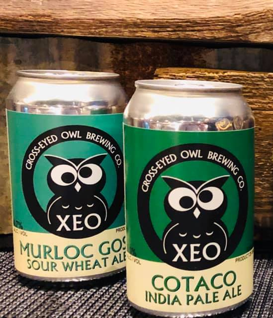 Two cans of xeo india pale ale sit on a table