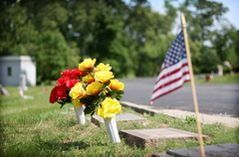 Veteran Memorial Stone With American Flag and Flowers