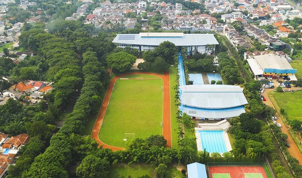 An aerial view of a soccer field and a swimming pool