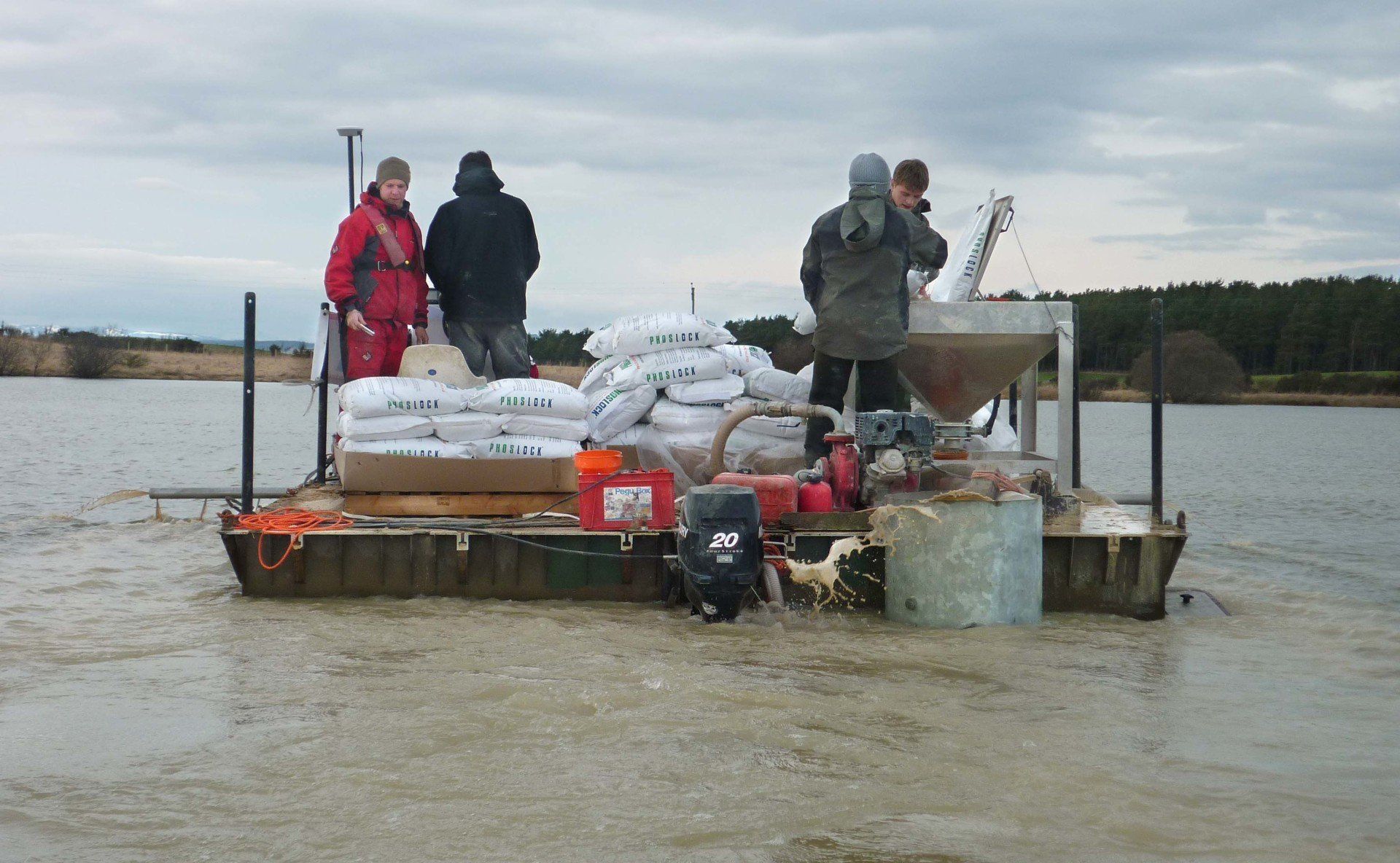 A group of people are standing on a boat in the water