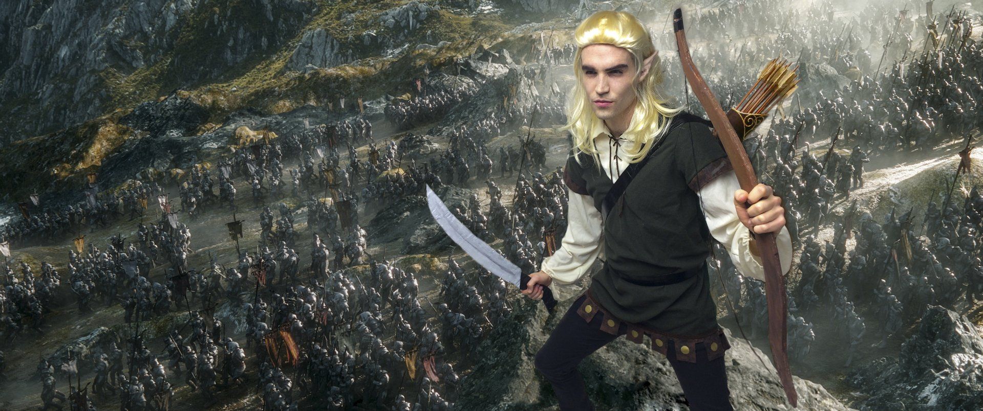 A person in an elf costume, holding a sword and bow, stands amidst a battle scene.