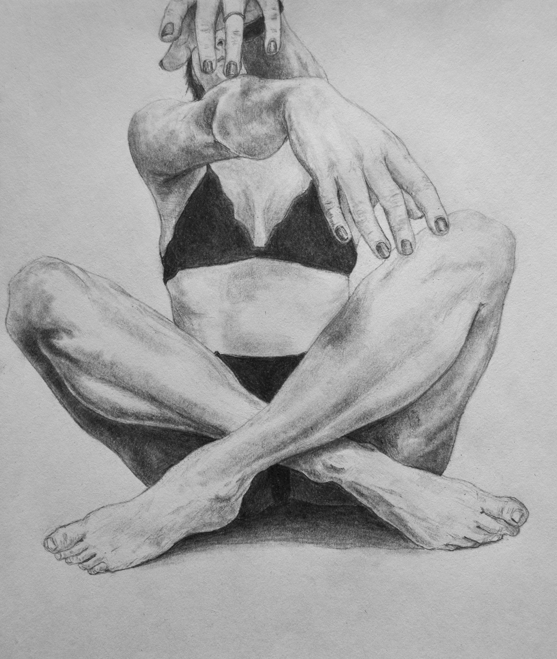 Figure in a bikini, seated cross-legged, arms crossed in front of face.