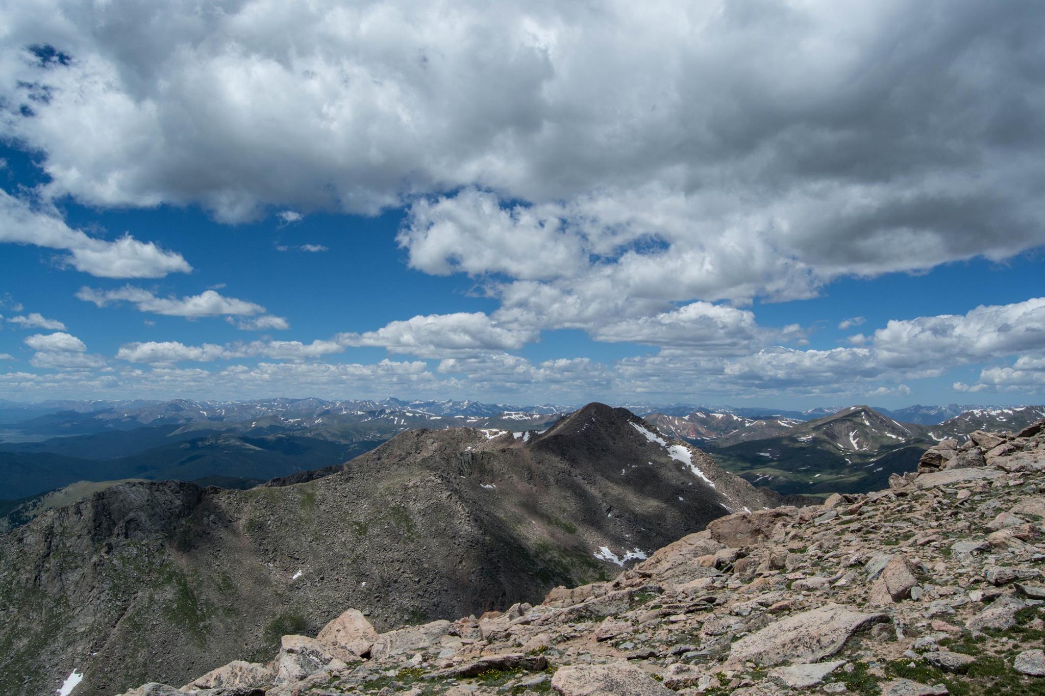 Rocky mountain range under a partly cloudy sky.
