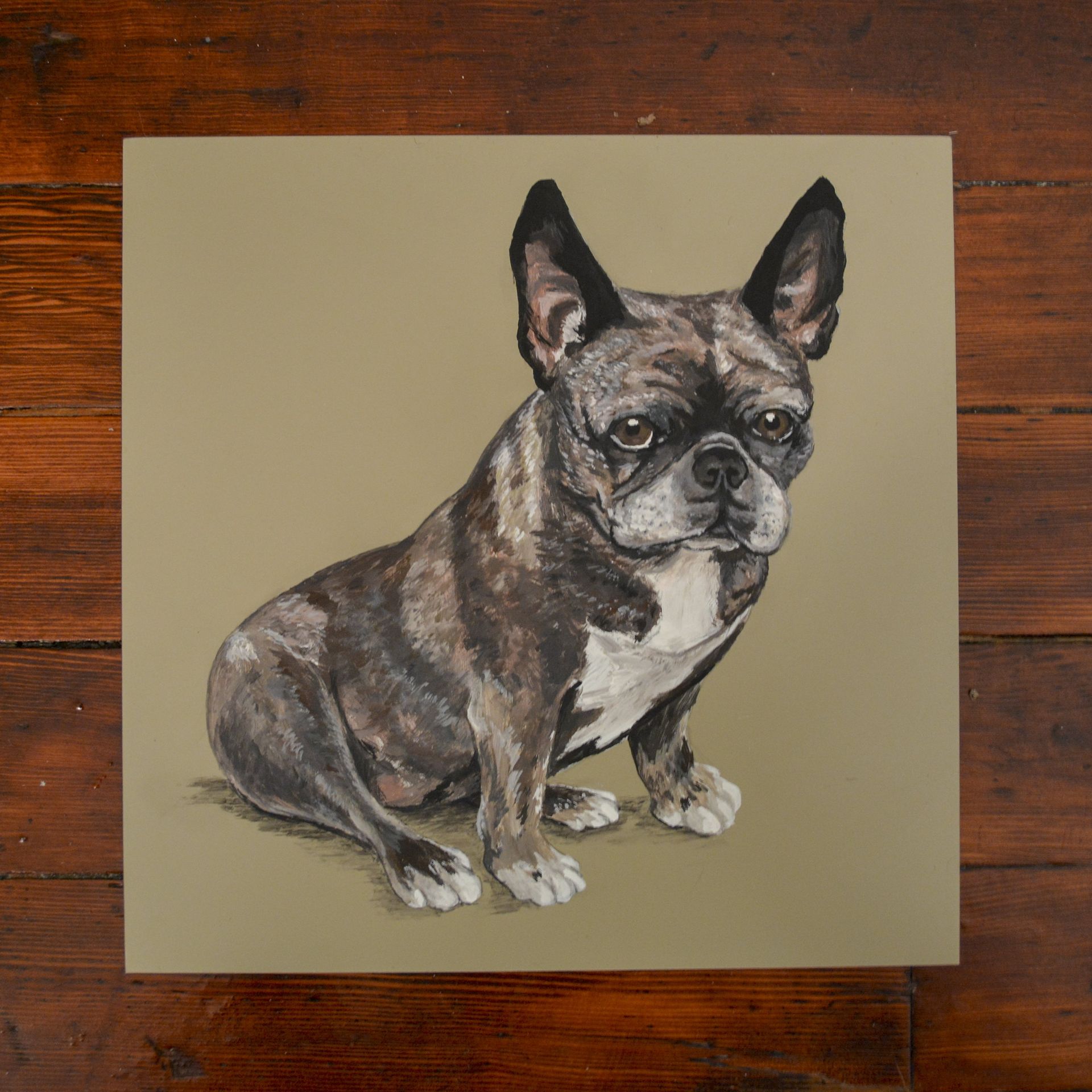 A watercolor portrait of a brindle French bulldog sitting on a tan background.