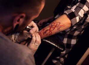 Tattoo Artist Works In Salon — Tattoo shop in Reno, NV Tattoo Artist Works In Salon — Tattoo shop in Reno, NV