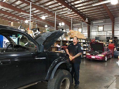 Hands of mechanic working in auto repair shop.
