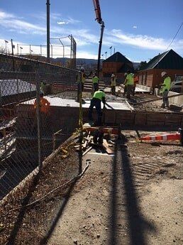 workers move dirt and concrete - municipal construction in WY