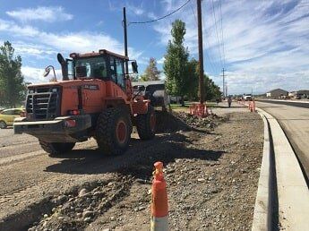 tractor moves dirt - road construction in WY