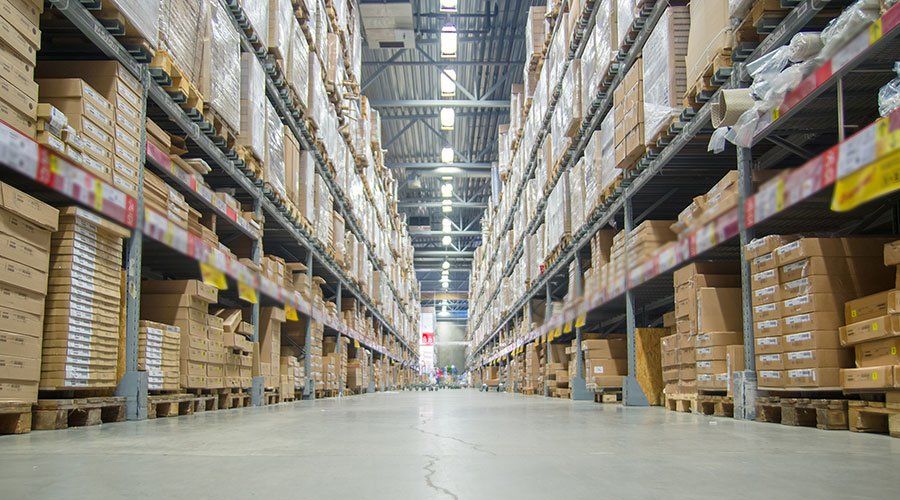 A large warehouse filled with lots of boxes on shelves.