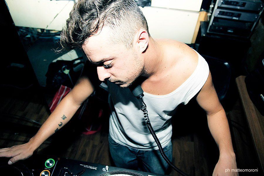 A man with a tattoo on his arm is playing music