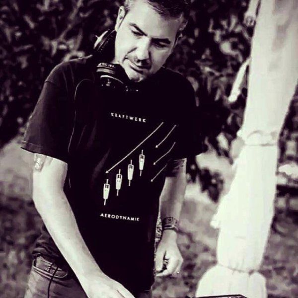A man wearing headphones and a shirt that says kraftwerk