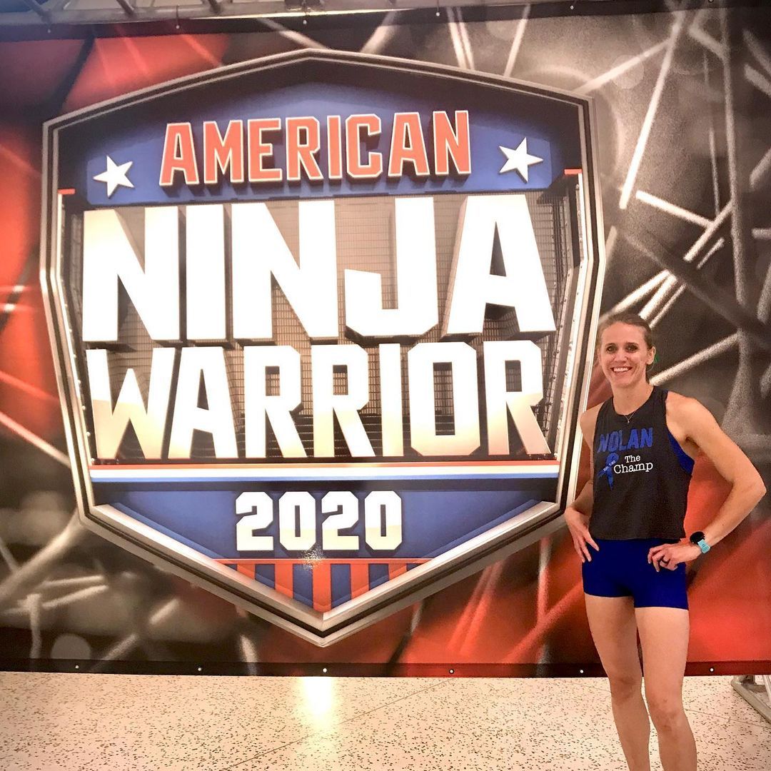 Woman in athletic wear stands in front of an