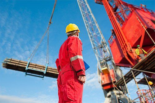 Construction Worker Looking At Crane
