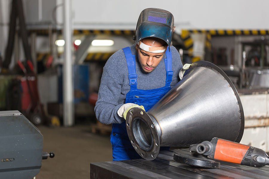 Welder Inspecting Metal Piece — New Concord, OH — 3-B Welding LLC