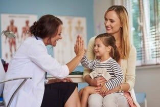 Doctor giving high-five to her patient — Primary Care in Colorado Springs, CO Doctor giving high-five to her patient — Primary Care in Colorado Springs, CO