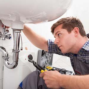 Plumber repairing sinks — Plumbing in Pompton Plains, NJ Plumber repairing sinks — Plumbing in Pompton Plains, NJ