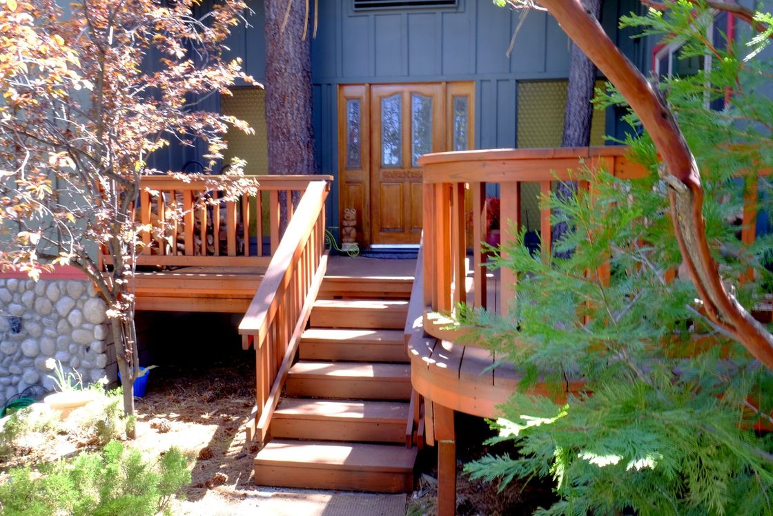 A wooden deck with stairs leading up to it