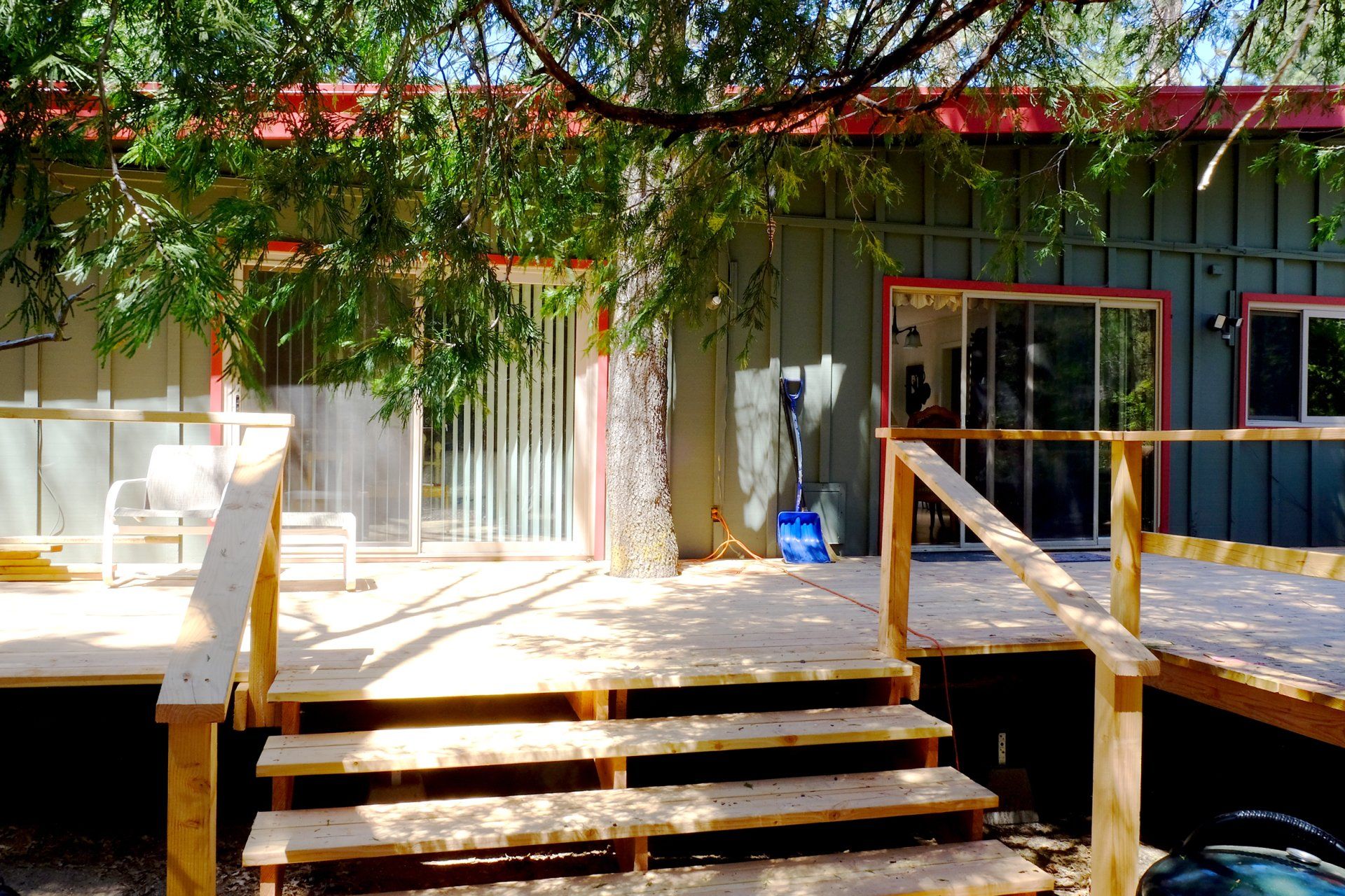 A house with a wooden deck and stairs in front of it