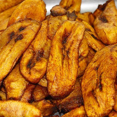 Pile of golden-brown fried plantains with crisp, caramelized edges