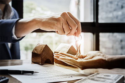 Estate agent giving house keys of customer and holding dollar us bank at agency office - agreement concept.