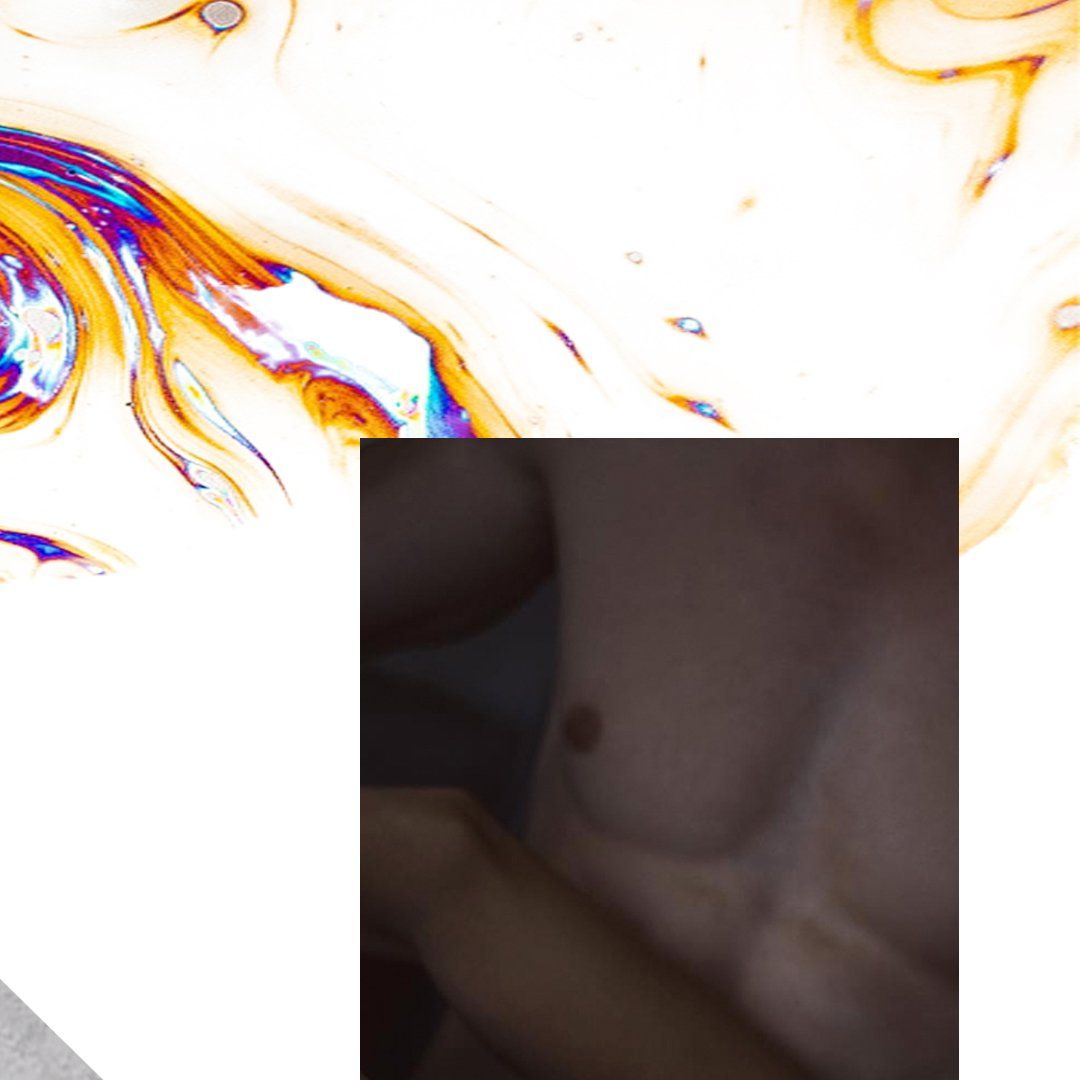 Torso, skin-toned, with one visible nipple. Dark background with a colorful, swirling pattern at the top.