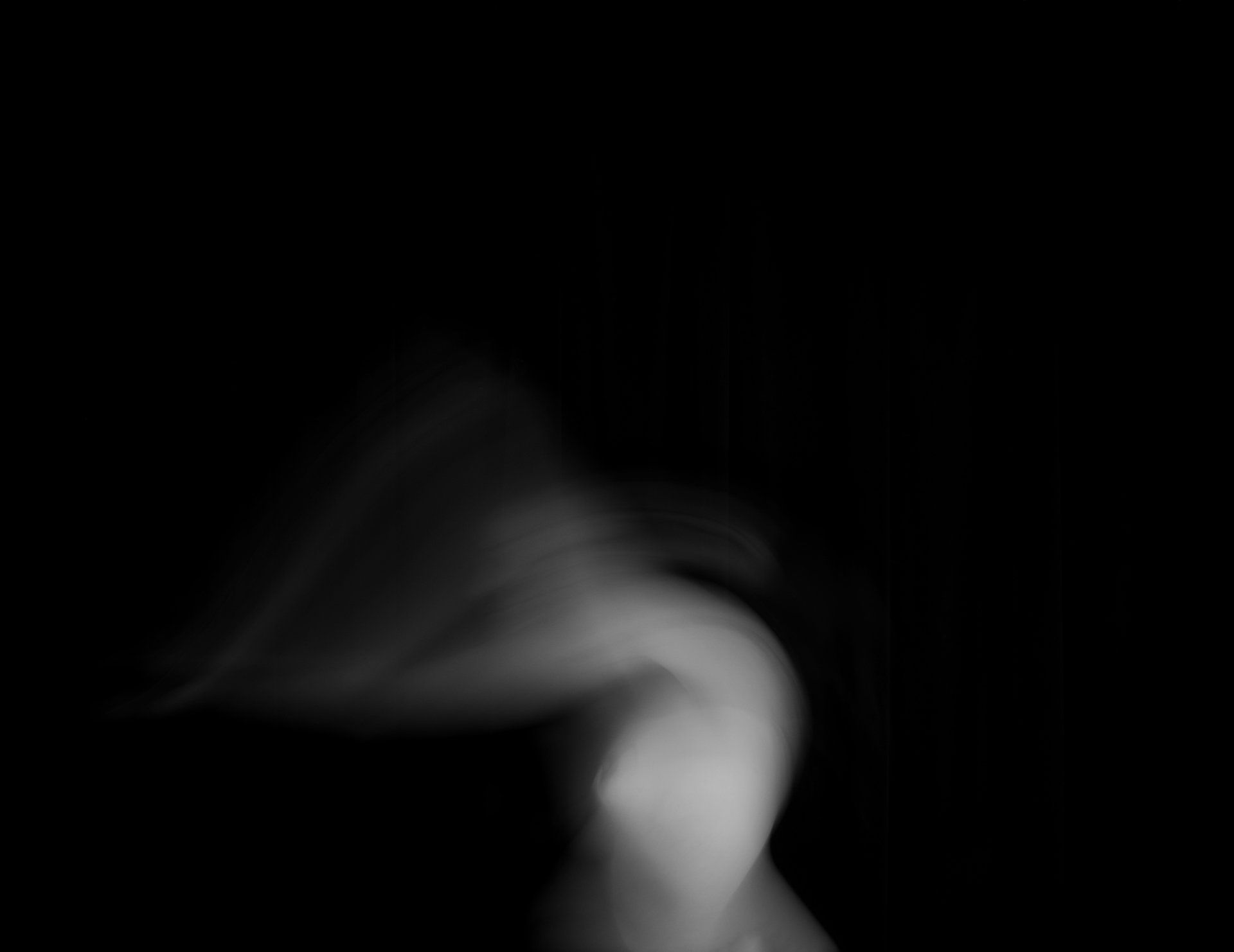 White smoke against black background, swirling upwards.