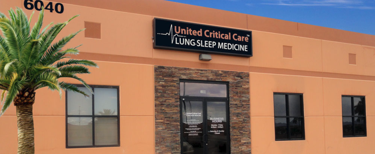 A large orange building with a palm tree in front of it. | United Critical Care