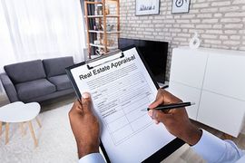 Person filling out real estate appraisal form
