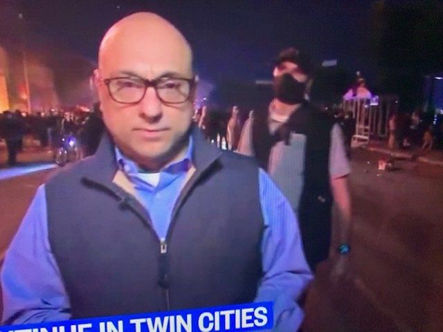 Bodyguard Protects Reporter During Protest