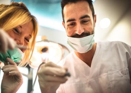 dentist and assistant smiling