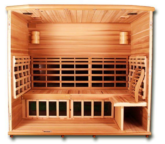 Wooden indoor sauna with bench seating and slatted walls, shown front-facing.