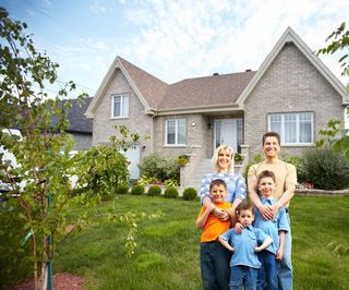 family in front of home