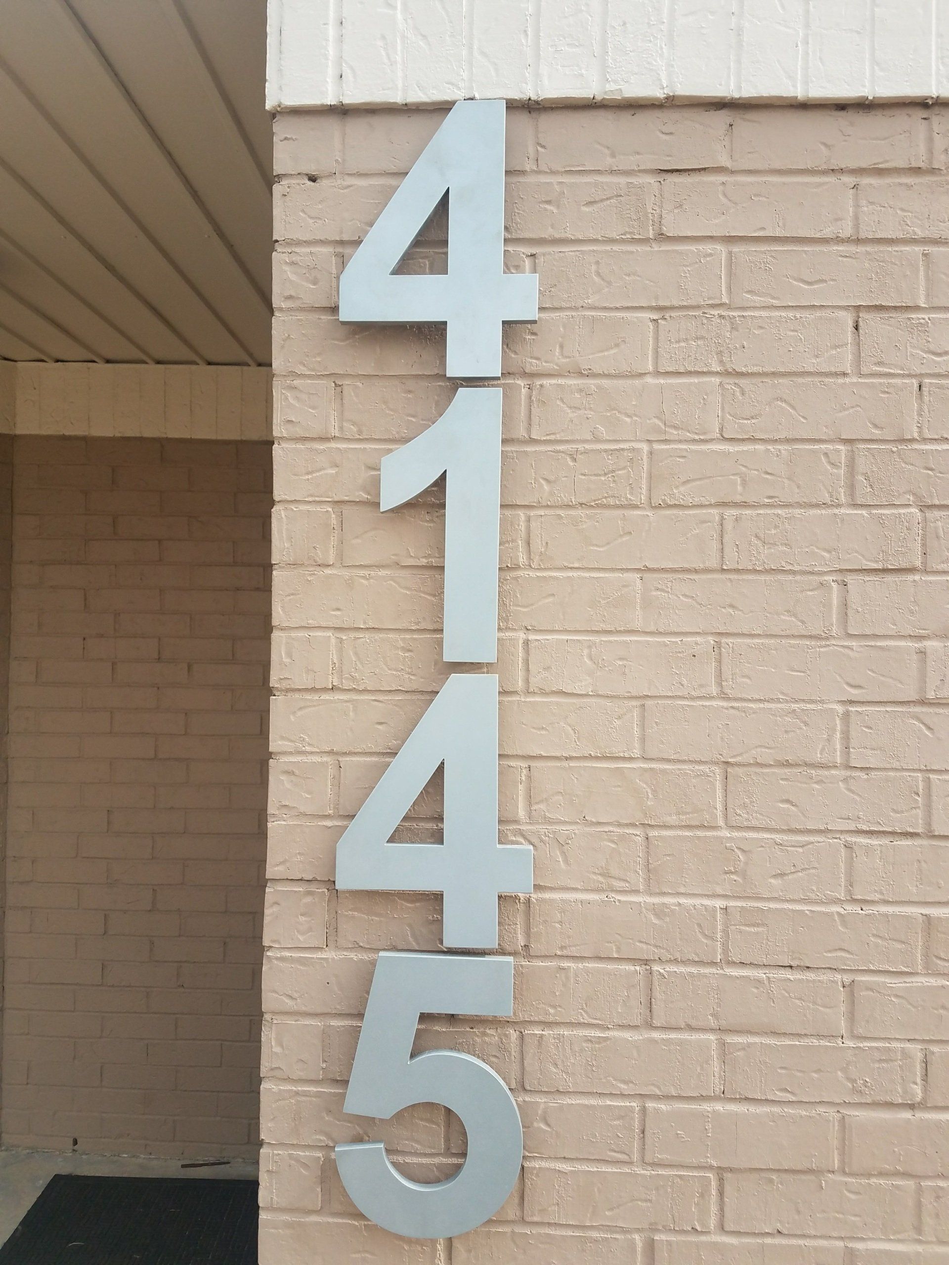 A brick wall with the number 4145 on it