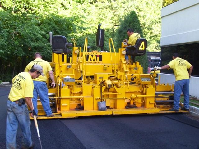 Worker Leveling Fresh Asphalt — Staten Island, NY — Margarella Worker Leveling Fresh Asphalt — Staten Island, NY — Margarella