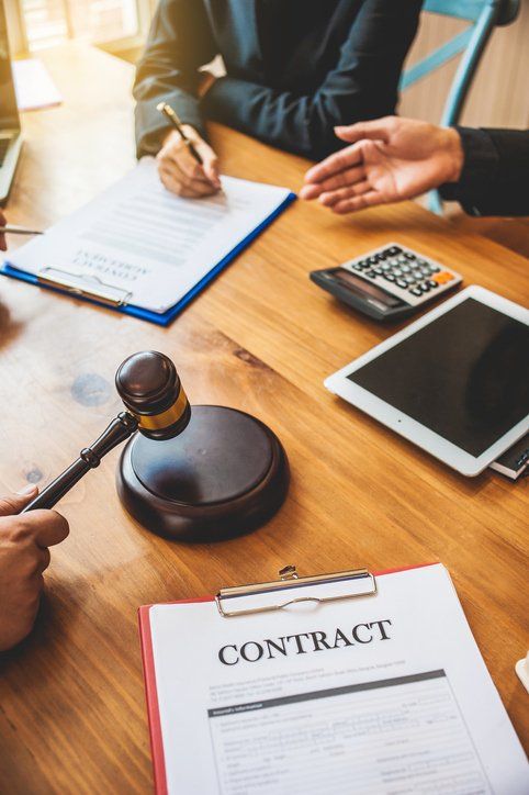 Business people and lawyers discussing contract papers