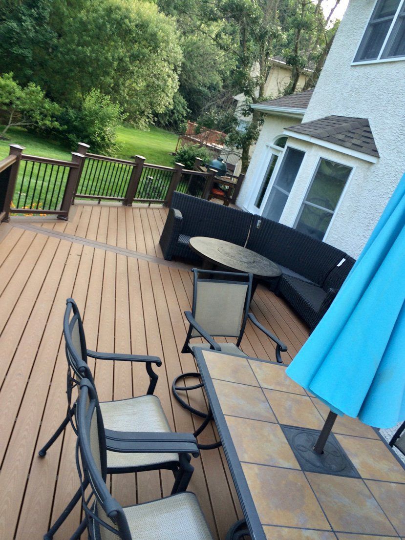 Deck With Blue Umbrella Table — Parkesburg, PA — E.P. Hannum Building