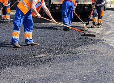 Workers on Asphalting road — Asphalt Service in West Bend, WI